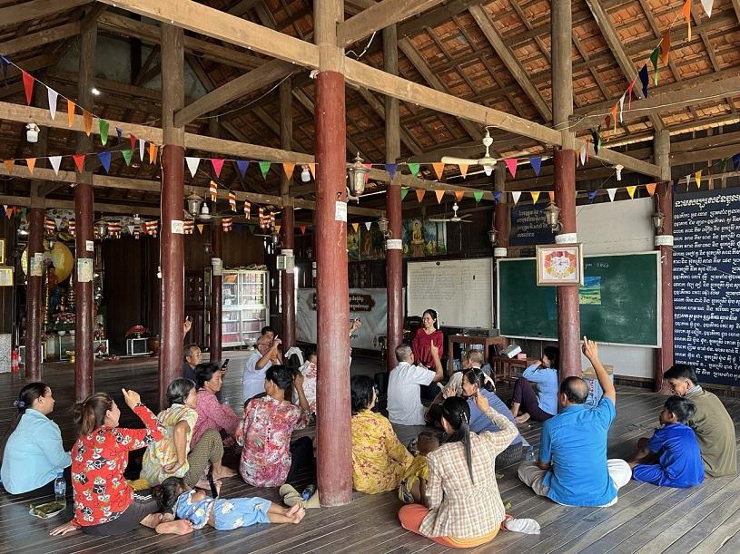People sitting together for a training session at a community centre.
