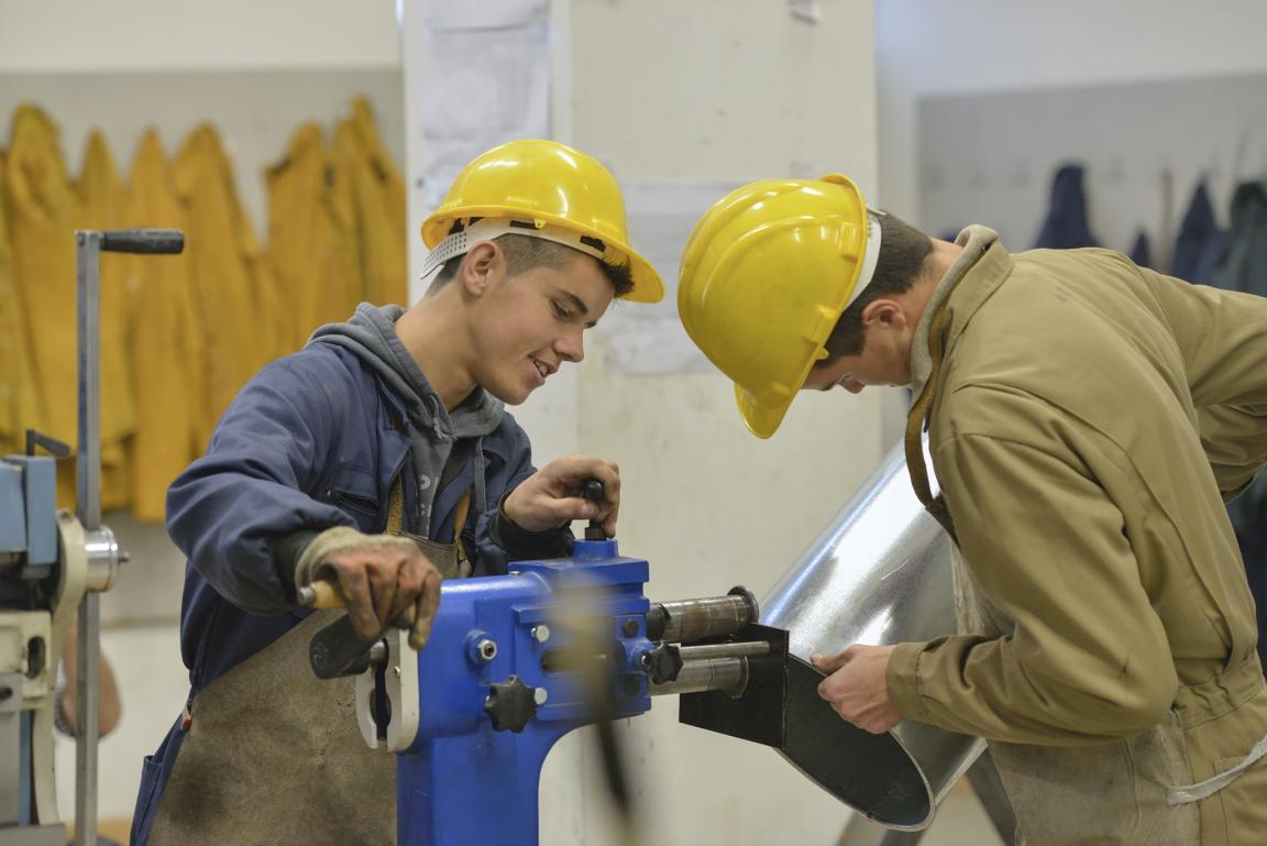 Two trainees working in a workshop.