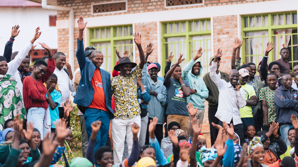 At a planning meeting, many people raise their hands to vote.