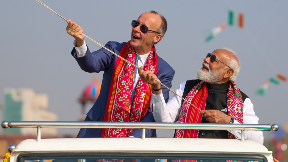 Premierminister Modi und Bundeskanzler Merz ziehen an einer Schnur.