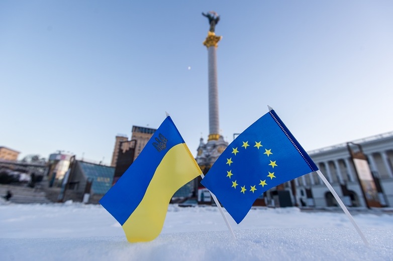The Ukrainian and the European flag in the snow on Maidan in Kiev