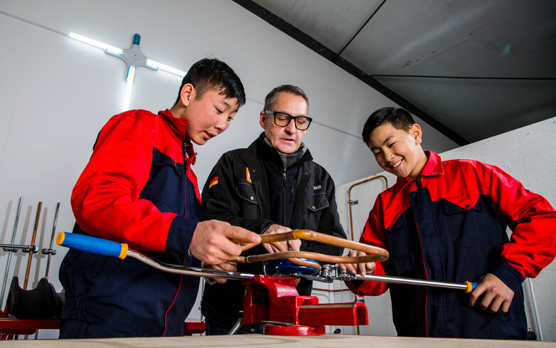Bild 3 Ein Mitarbeiter aus der Entwicklungsarbeit in der praktischen Anwendung mit Auszubildenden, GIZ Mongolei