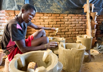 Malawi. A boy making improved cooking stoves, supported by the Energizing Development Programme in Malawi © GIZ