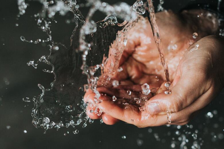 Hands gathering fresh water