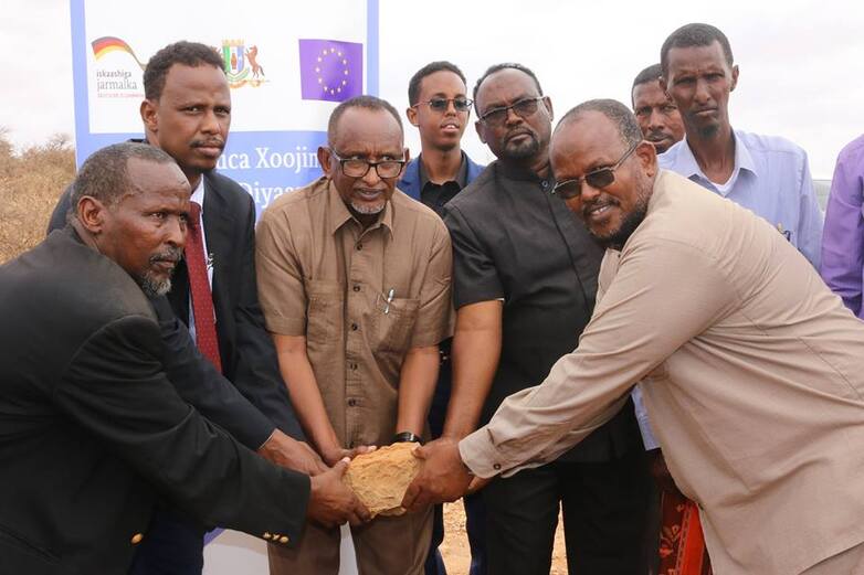 Government officials from MOEACC and community elders during groundbreaking event in Puntland