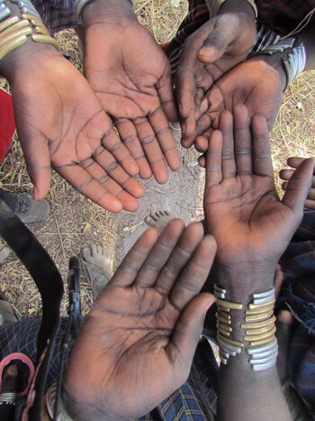 A symbol of community and solidarity: a gesture used by the Mursi people of Ethiopia