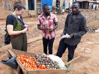 A woman and two men in conversation during data collection for dietary behaviour research. 