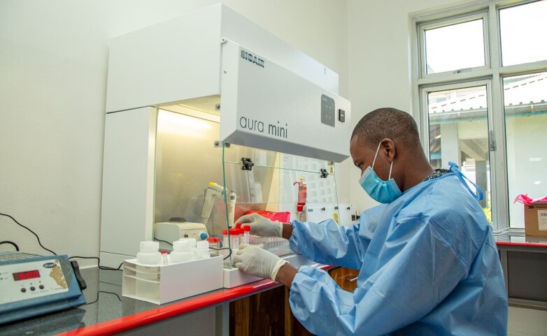 A laboratory employee examines samples.