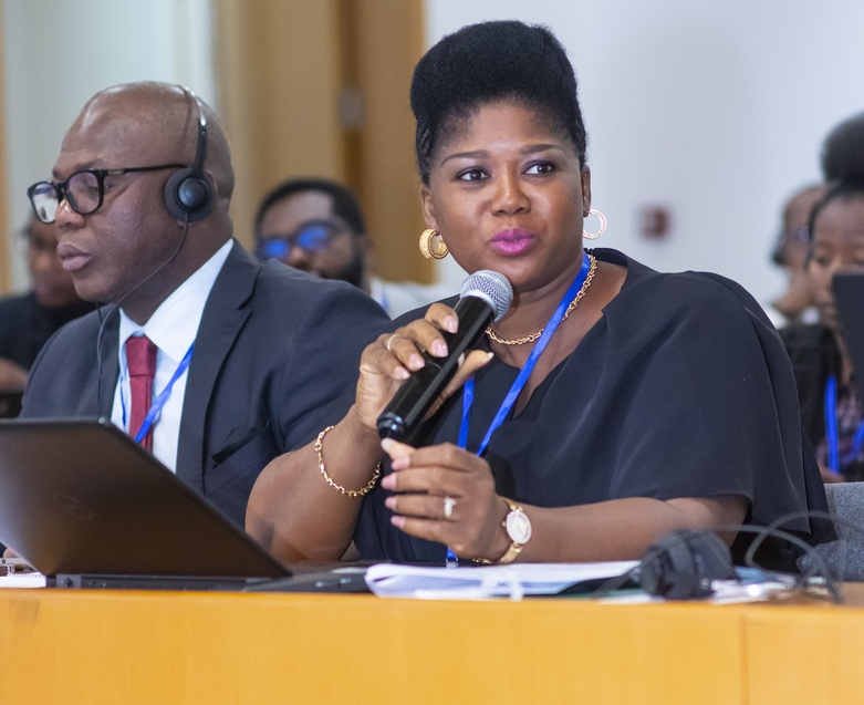 A lady talking at a conference.