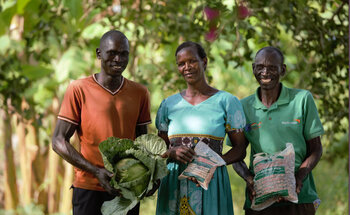 3 people hold produce and locally produced quality seeds