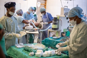 Medical and nursing specialists treat a patient in the operating theatre in Zomba Hospital in Malawi.