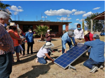 Members of the public setting up a solar panel together