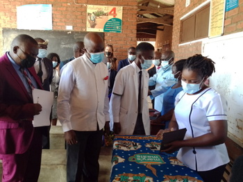 Nurse demonstrating a digital tool to the Deputy Minister of Health Enock Phale during the launch of the e-Register platform 