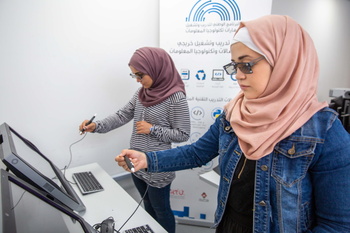 Two female students participating in the up-skilling programme work with an Augmented Reality Tool 