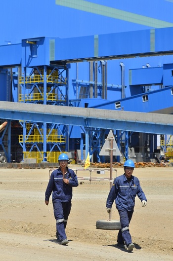 Two employees walking on the plant premises