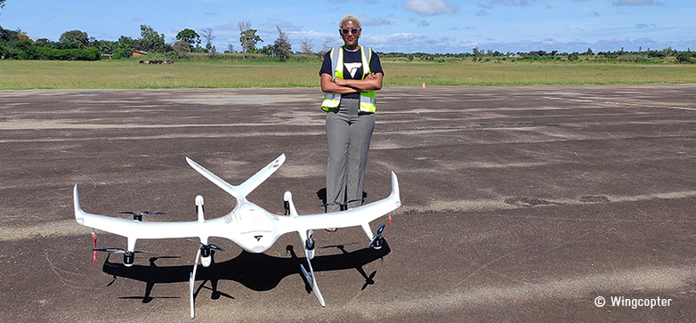 A person standing in front of a drone.