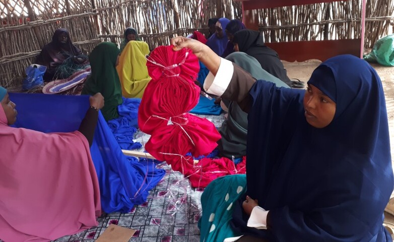 Women are working with cloth.