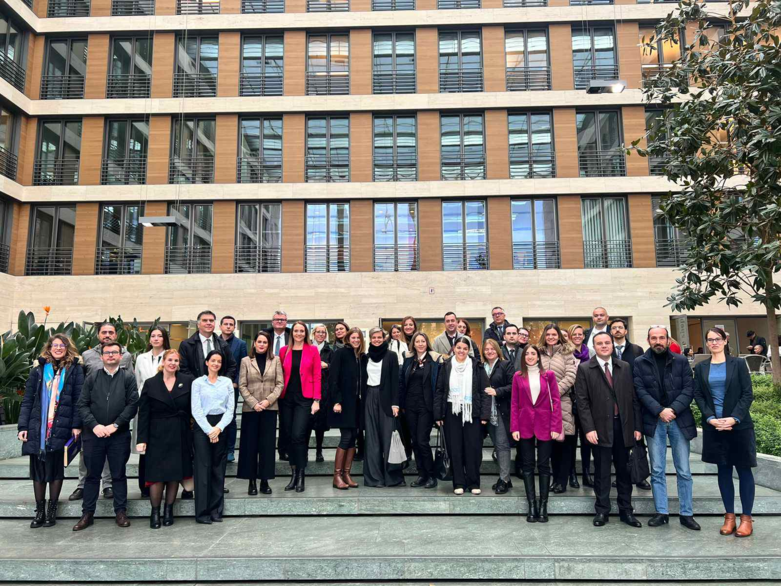 People stand together on steps in front of a building.