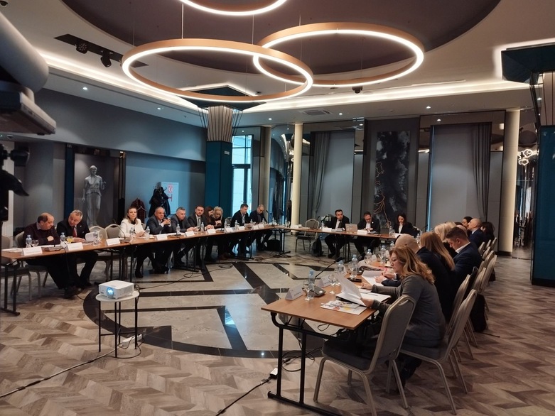 People sit at tables at a conference.