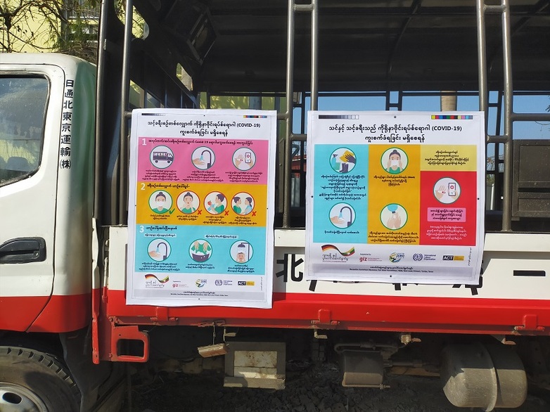 Two posters on COVID-19 prevention hanging on a truck in Myanmar Copyright: FABRIC Project 