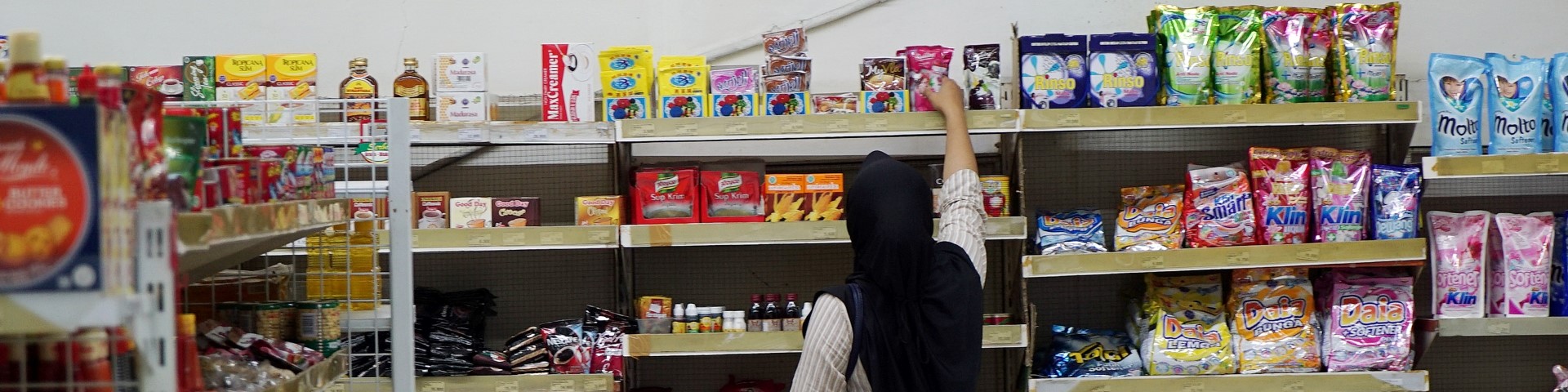 Woman hand at a supermarket shelf