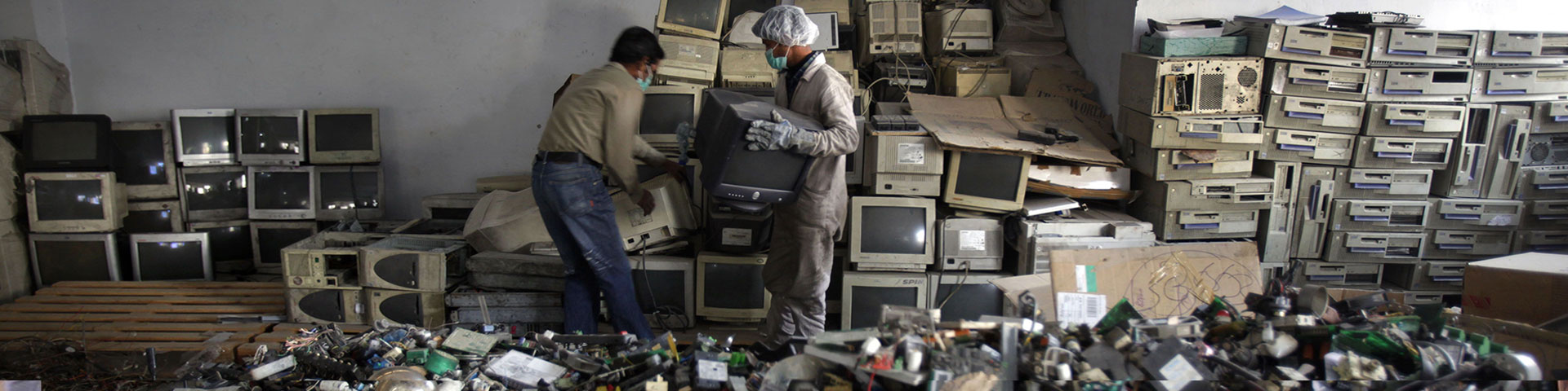 Two people dismantling and recycling e-waste