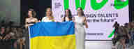 A group of women holding a Ukrainian flag.