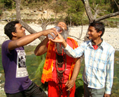 Nepal. Breaking a taboo: A Dalit, a high-caste teenager and a Hindu priest share water.