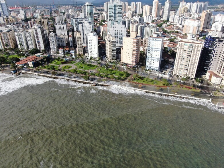 The skyline of a city at a coastline which is being hit by a storm. 