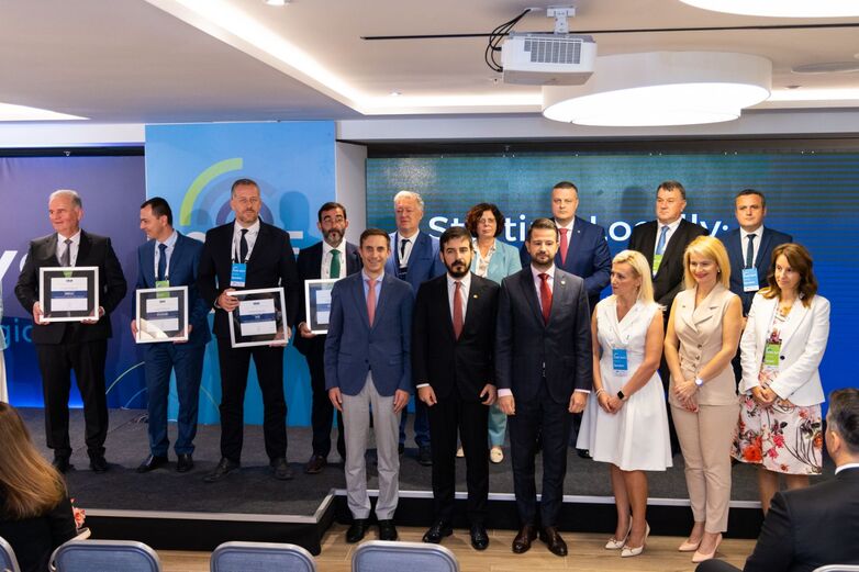 A group of people stand in front of a podium.