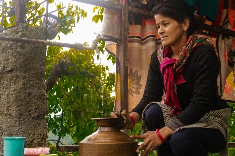 A woman filling water to carry out everyday household chores