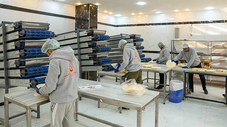 Men working in a production hall of a small enterprise.