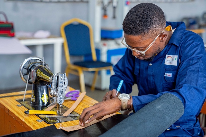 Female beneficiary of electrical training working on an inverter during her internship in Lagos State. Photo date – July 2019