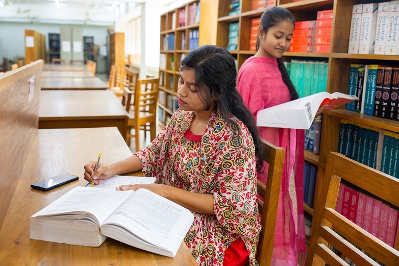 Women are gathering information in a library.