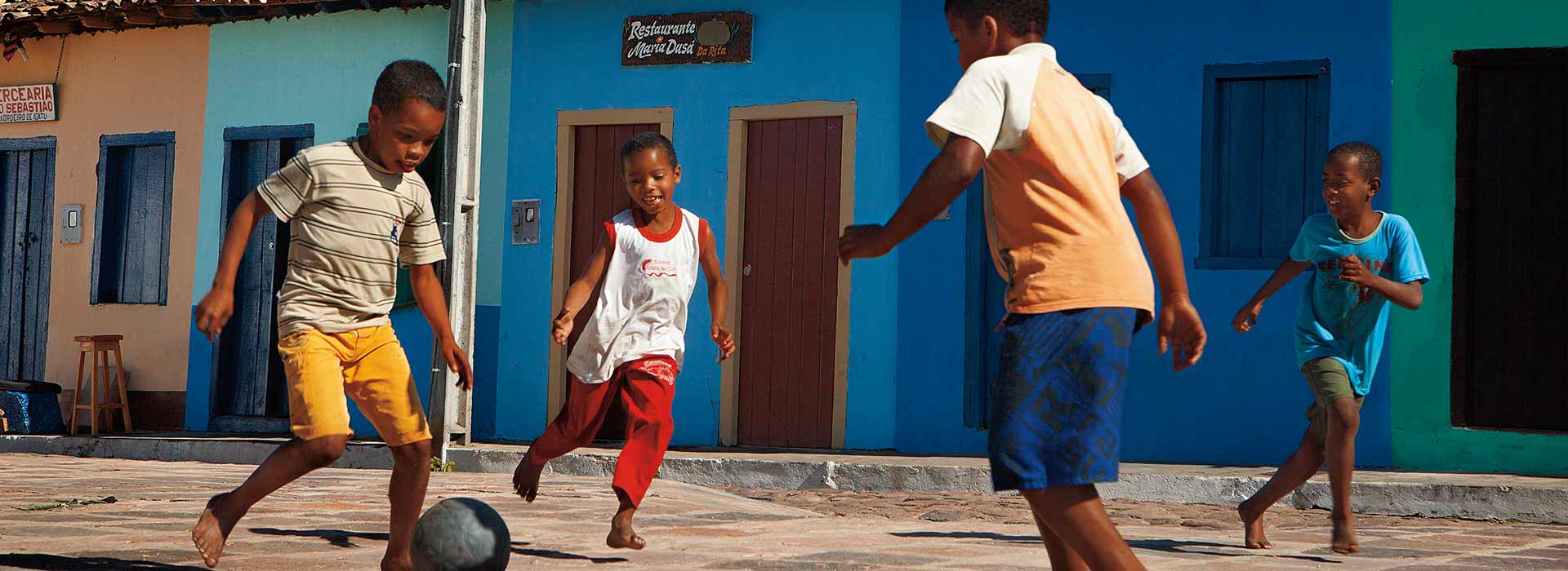 Boys playing football in the street