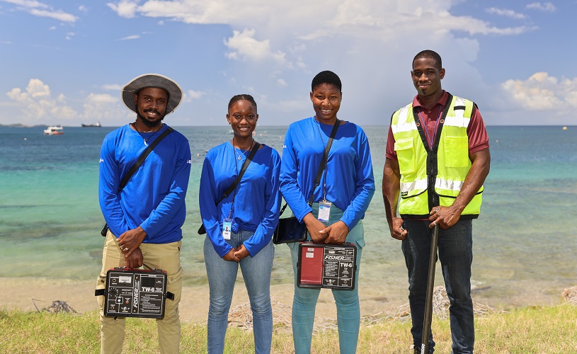 Employees of the Grenadian water supplier with equipment.