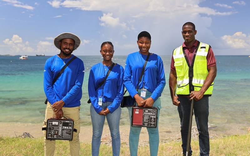 Employees of the Grenadian water supplier with equipment.