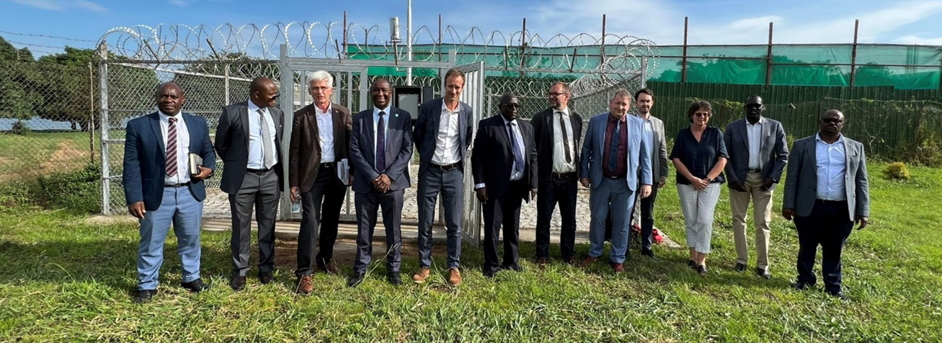 A group of people standing in front of a measuring station.