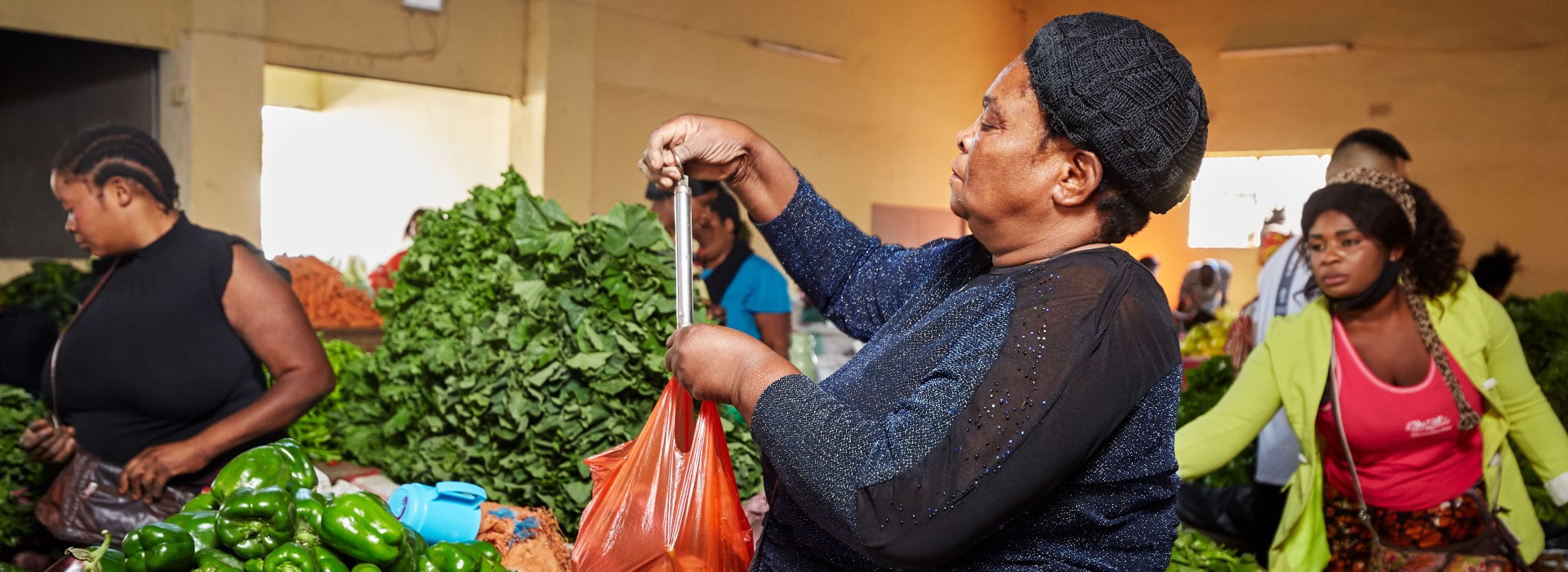 A group of people in a food market.