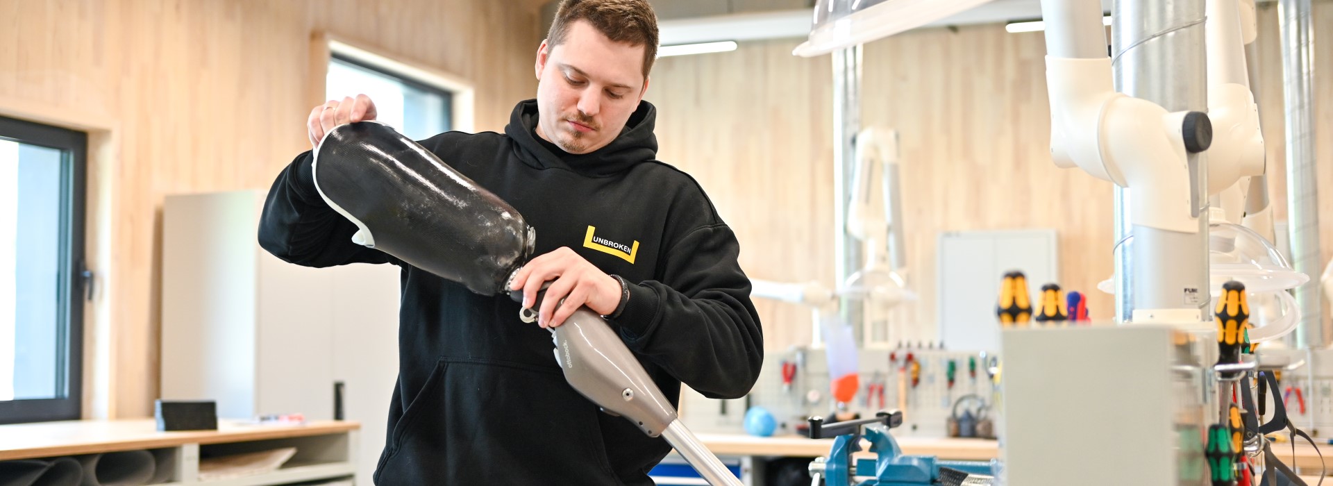 A man is working on a prosthetic leg.